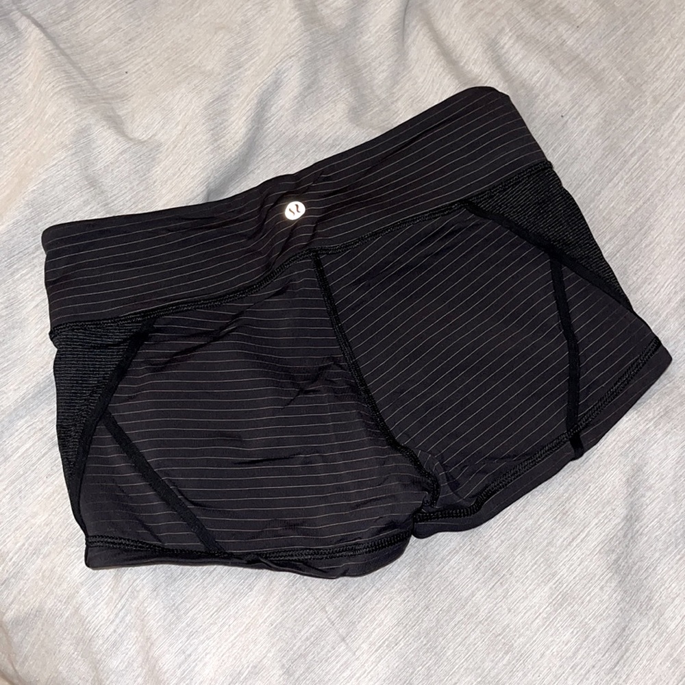 Lululemon Athletica woman’s black and gold striped shorts